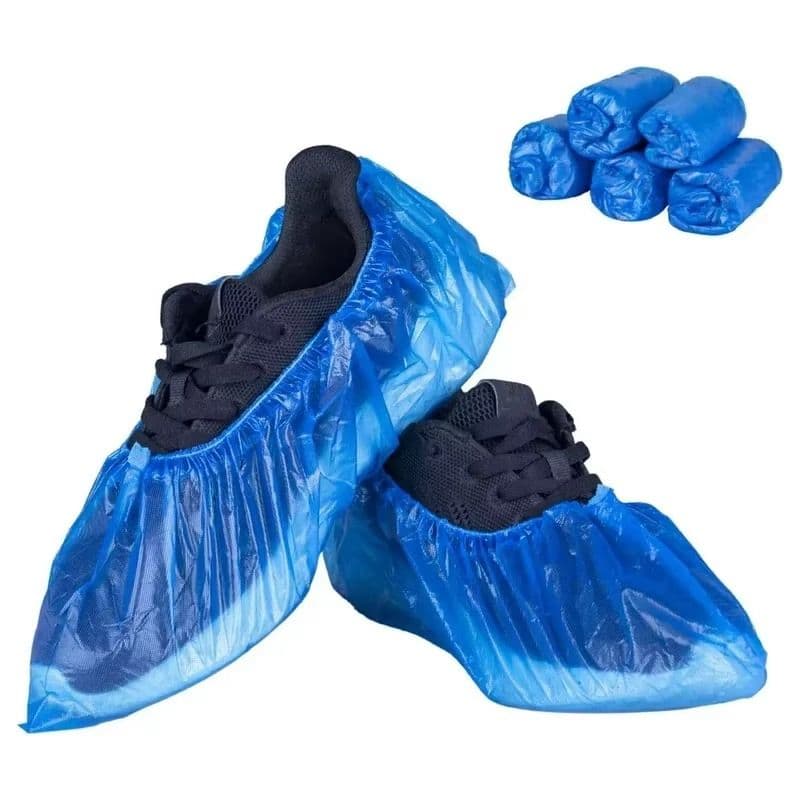 Disposable non-woven polypropylene shoe covers with elasticated ankle band for secure fit over all shoe sizes. Low-lint, latex-free, and breathable. Prevents contamination transfer from outdoor footwear into clean environments. Available in blue and white. Ideal for hospitals, laboratories, cleanrooms, food processing facilities, and construction site visitor areas.
